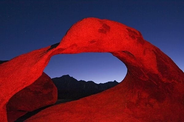 USA, California, Alabama Hills, Night photo of rock arch with colored flash
