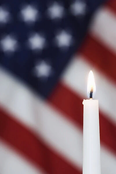 USA, California. Burning candle and American flag