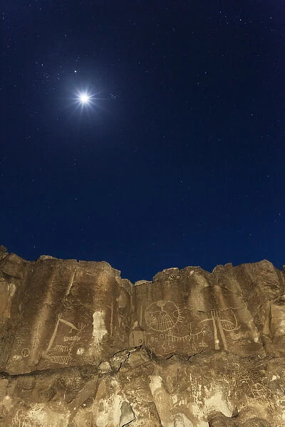 USA, California, Chalfant Canyon. Petroglyph designs on rock face at night. Credit as