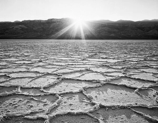 USA, California, Death Valley National Park. Sunburst on Badwater salt flats. Credit as