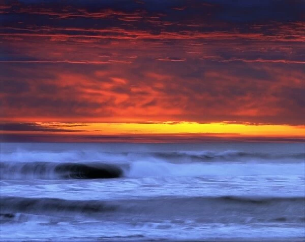 USA, California, Del Norte Co. Dramatic clouds and breaking waves end the day