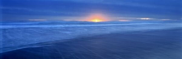 USA, California, Del Norte Co. The sun glints through storm clouds on the Del Norte