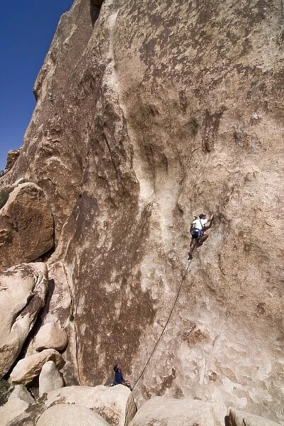USA, California, Joshua Tree National Park. A rock climber on one of the parks many climbs