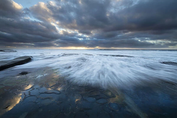 USA, California, La Jolla. Wave washes over tidepools
