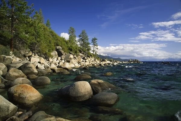 USA, California, Lake Tahoe. Smooth granite boulders line the lake shore in clear water