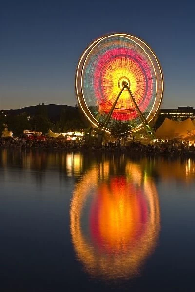 USA, California, Marin County. Spinning ferris wheel reflects in lake at Civic Center Fairgrounds