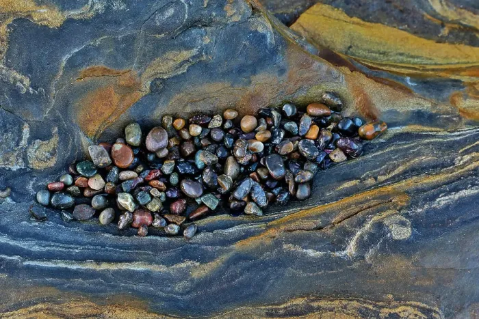 Framed Print : USA, California, Point Lobos State Natural Reserve. Blue and gold tone rocks at low tide with colorful small pebbles