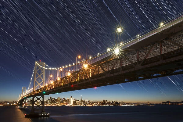 USA, California, San Francisco. Composite of star trails above Bay Bridge. Credit as