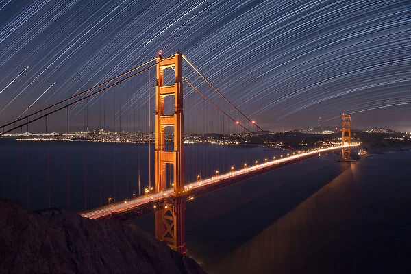 USA, California, San Francisco. Composite of star trails above Golden Gate Bridge