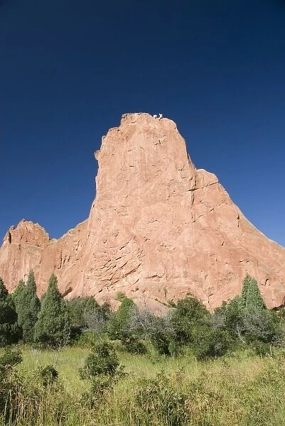 USA, Colorado, Colorado Springs, Garden of the Gods. Rock climbers atop famous red rock formations