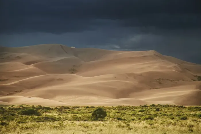 Framed Print : USA, Colorado, Great Sand Dunes National Park. Thunderstorm over sand dunes near sunset