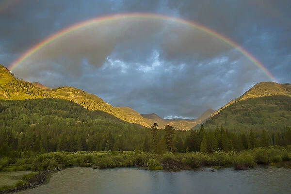 USA, Colorado, Gunnison National Forest. Rainbow over Slate River Valley. Credit as