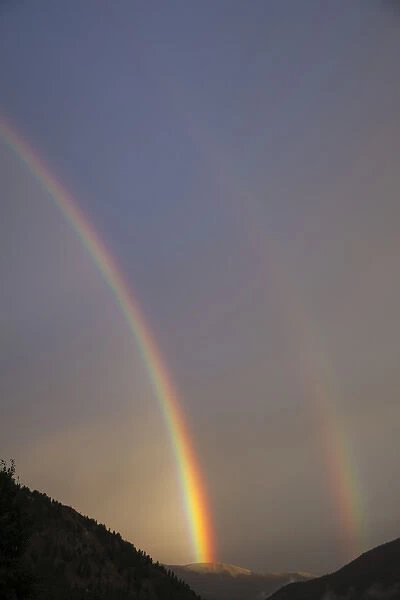 USA, Colorado, Lake City. A double rainbow forms over mountains
