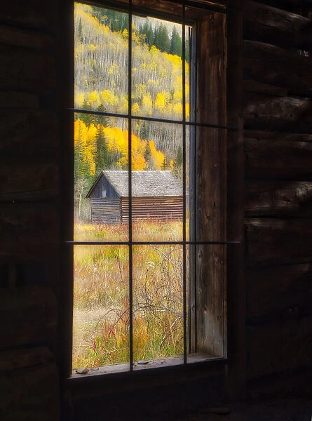 USA, Colorado. Looking out a window in the ghost town of Ashcroft in autumn near Aspen