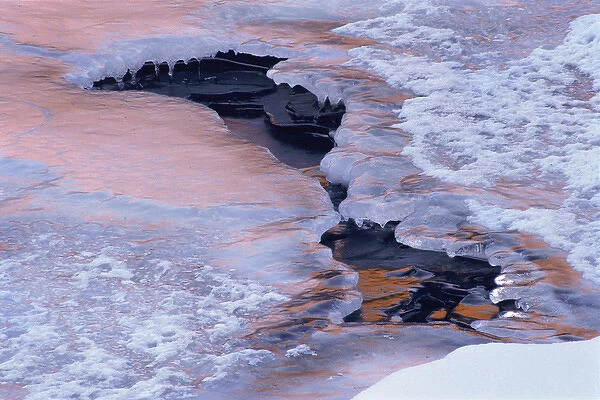USA, Colorado, Lyons. Ice and snow pattern in Saint Vrain River at sunset. Credit as