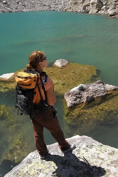 USA, Colorado, Rocky Mountains, Indian Peaks Wilderness. A female hiker at a mountain lake