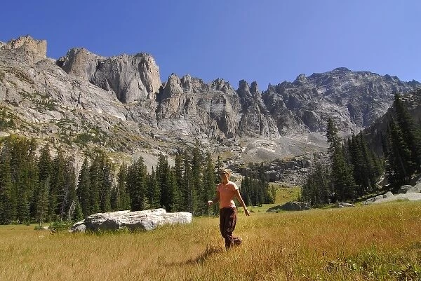 USA, Colorado, Rocky Mountains, Indian Peaks Wilderness. A female hiker passes through