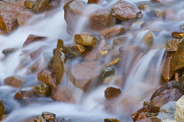 USA, Colorado, Rocky Mountains, Ophir Pass. Small waterfall cascades over rocks. Credit as