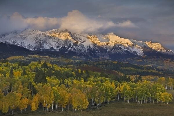 USA, Colorado, Rocky Mountains. Sunrise warms the peaks of the Sneffels Range in autumn
