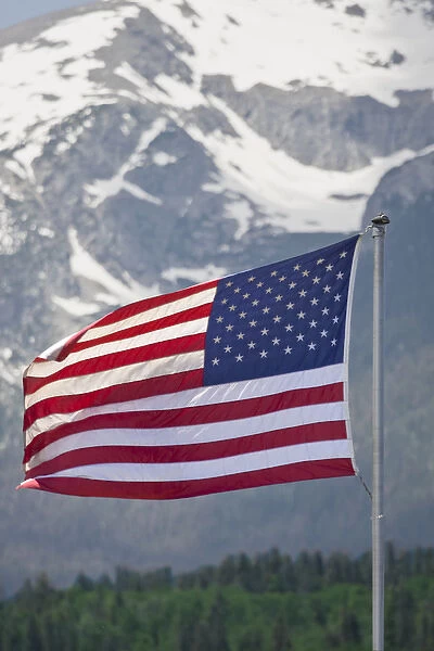 USA, Colorado, Silverthorne. American flag flying against mountain backdrop. Credit as Fred J