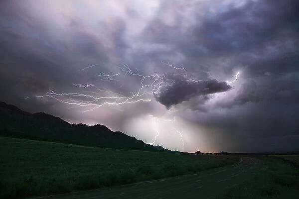 USA, Colorado, Upper Arkansas River Valley. Lightning storm over mountain. Credit as