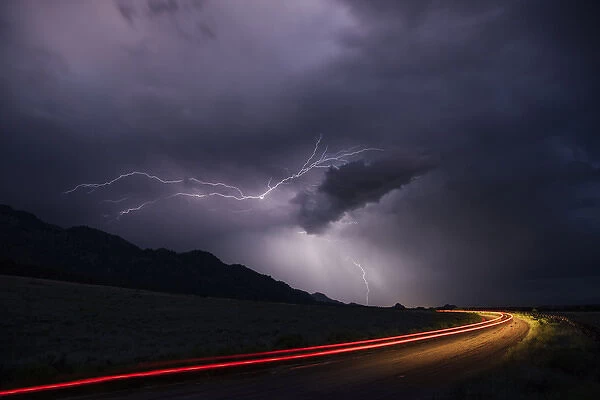 USA, Colorado, Upper Arkansas River Valley. Lightning stormover vehicle light track