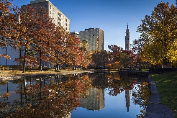 USA, Connecticut, Hartford, Bushnell Park, reflection of office buildings and Travelers Tower