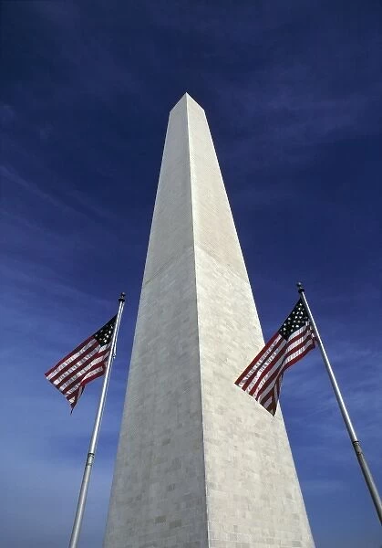 USA, District of Columbia. Waving American flags accent the stately Washington Monument