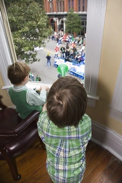 USA; Georgia; Savannah. Two young boys watching the St. Patricks Day Parade. (MR)
