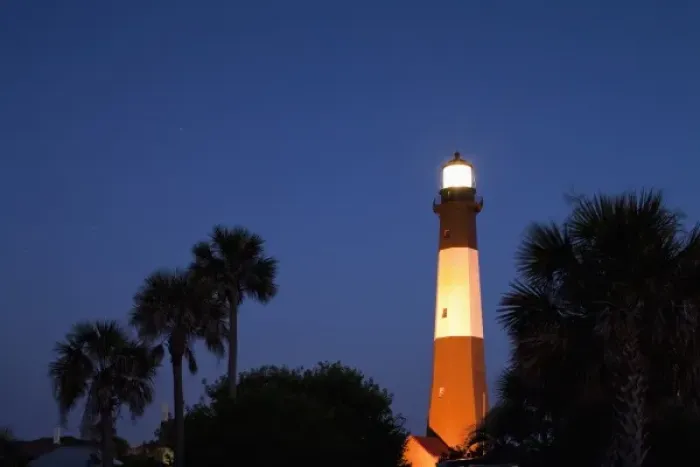 Framed Print : USA, Georgia, Tybee Island, Palmetto Palm trees and Tybee Lighthouse at dusk on summer