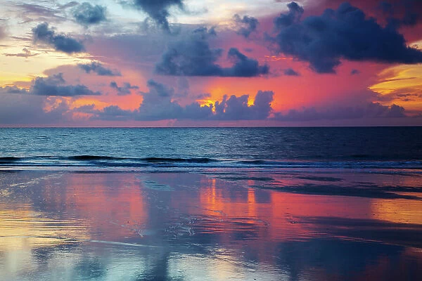 USA, Georgia, Tybee Island. Sunrise with reflections and clouds
