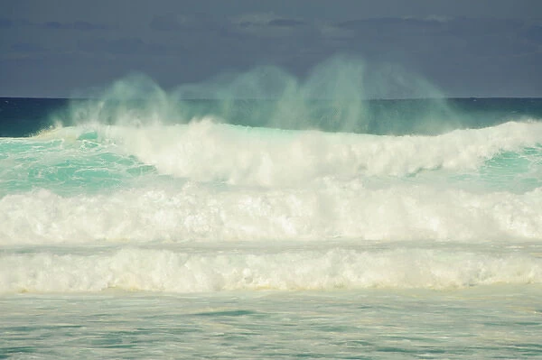 USA, Hawaii, Maui. A wave with ghosts egins its tumble on Mauis North Shore beach