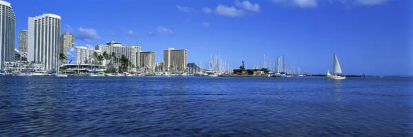 USA, Hawaii, Oahu, Honolulu. Waikikis shoreline is punctuated by bright buildings
