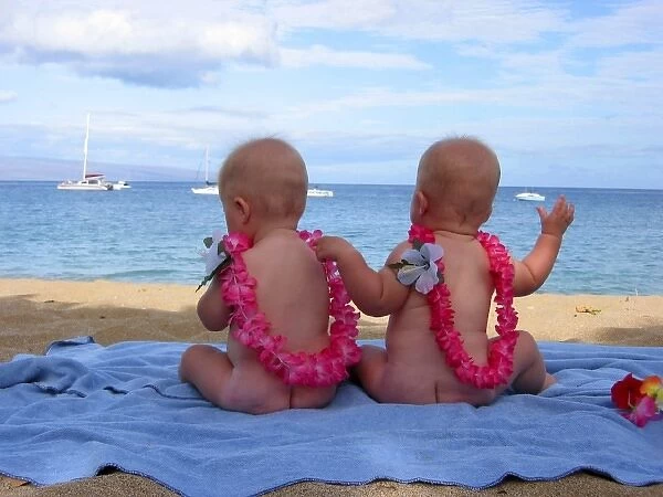 USA. Hawaiian Islands. Maui. Twin babies enjoy the beach. (MR)