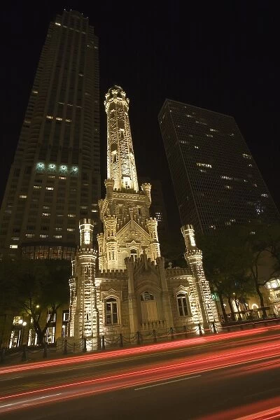 USA, Illinois, Chicago. Traffic lights blur past the Water Tower on Michigan Avenue