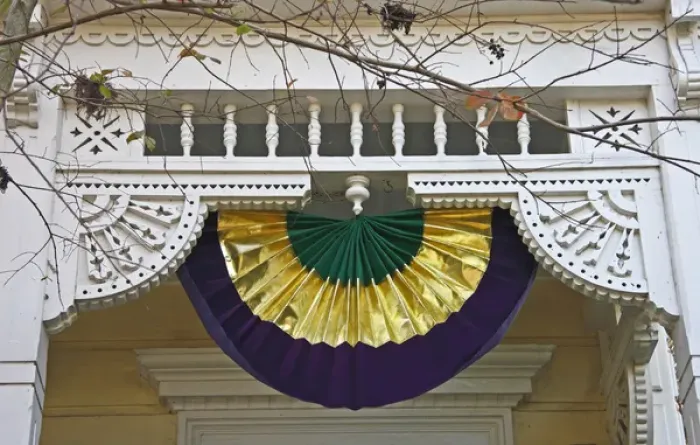 Framed Print : USA, Louisiana, New Orleans, Garden District. A Mardi Gras decoration hangs from Victorian fretwork