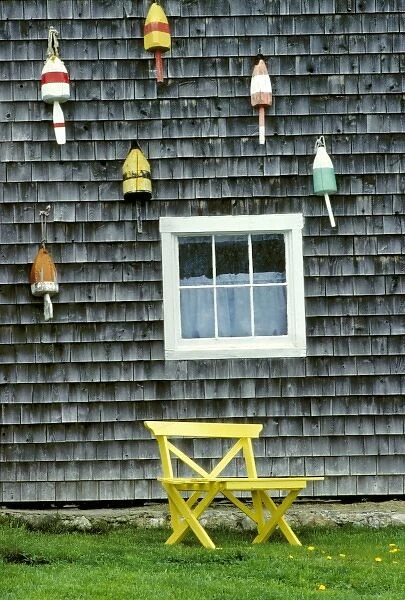 USA, Maine, Boothbay Harbor. Buoys decorate a shingled wall in Boothbay Harbor, Maine