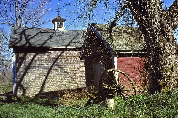 USA, Maine, Boothbay Harbor. Wooden farm buildings are decorated by the shadows of