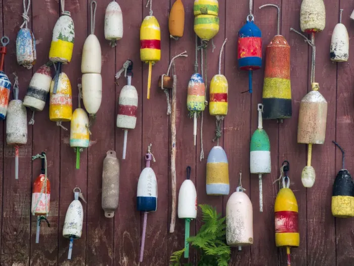 Framed Print : USA, Maine. Colorful buoys hanging on the exterior of a building
