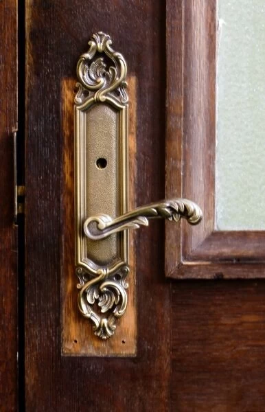 USA, Maine. Ornate handle on wooden door