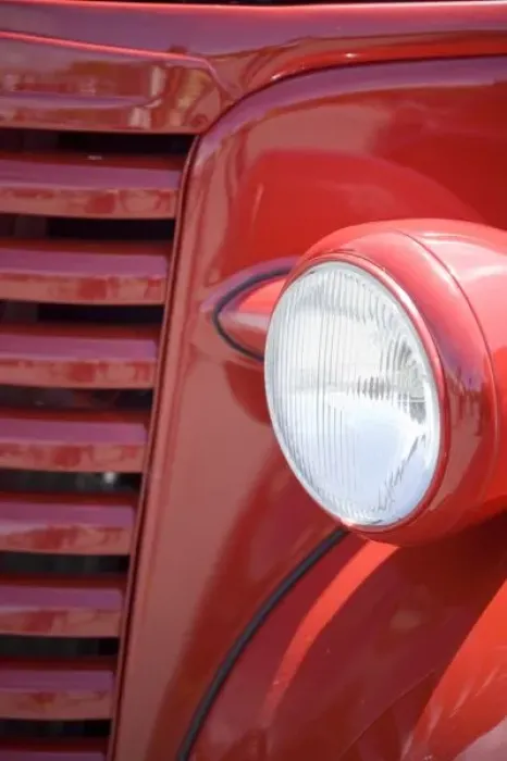 Framed Print : USA, Maine, Owls Head. Headlight and partial grill of a red antique truck. Credit as
