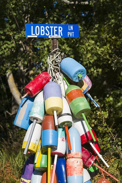 USA, Maine, Owls Head, sign for Lobster Lane with lobster buoys