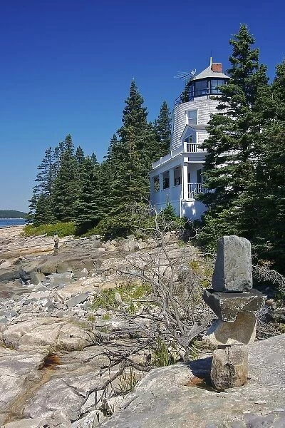 USA, Maine, Schoodic Peninsula. A home with a lighthouse-like tower above the rocks