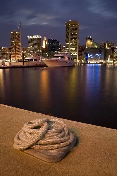 USA, Maryland, MD, Baltimore. A rope is coiled at a dock with the city reflected