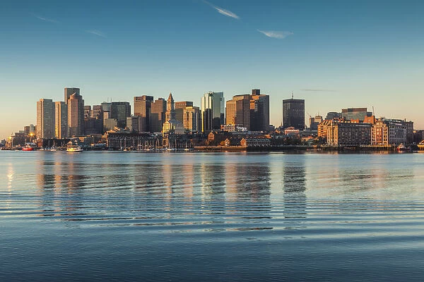 USA, Massachusetts, Boston. City skyline from Boston Harbor at dawn