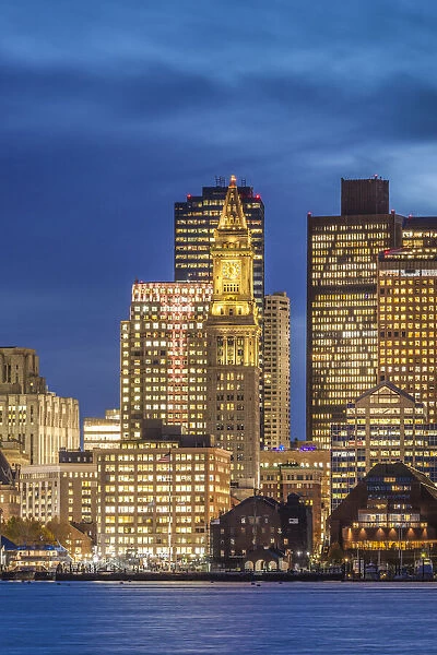 USA, Massachusetts, Boston. City skyline from Boston Harbor at dusk