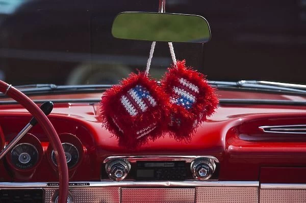 USA, Massachusetts, Gloucester. Fuzzy dice with US flag in 1950s-era convertible, antique car show