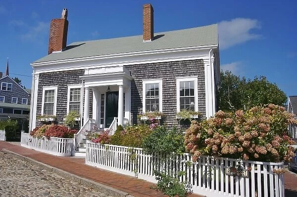 USA, Massachusetts, Nantucket. A pretty shingled house on a cobblestone street