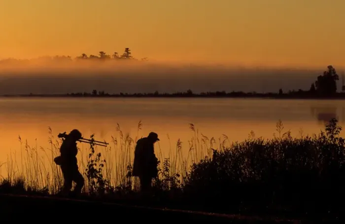 Framed Print : USA, Michigan, Drummond Island, Photographers after sunrise walking along Potagannissing