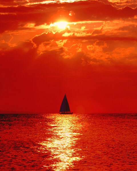 USA, Michigan, Mackinaw, Lake Huron. Sailboat at dawn. Credit as: David W. Kelley